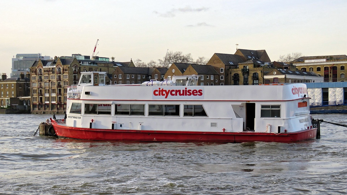A river cruise boat on the Thames passing Tower Bridge